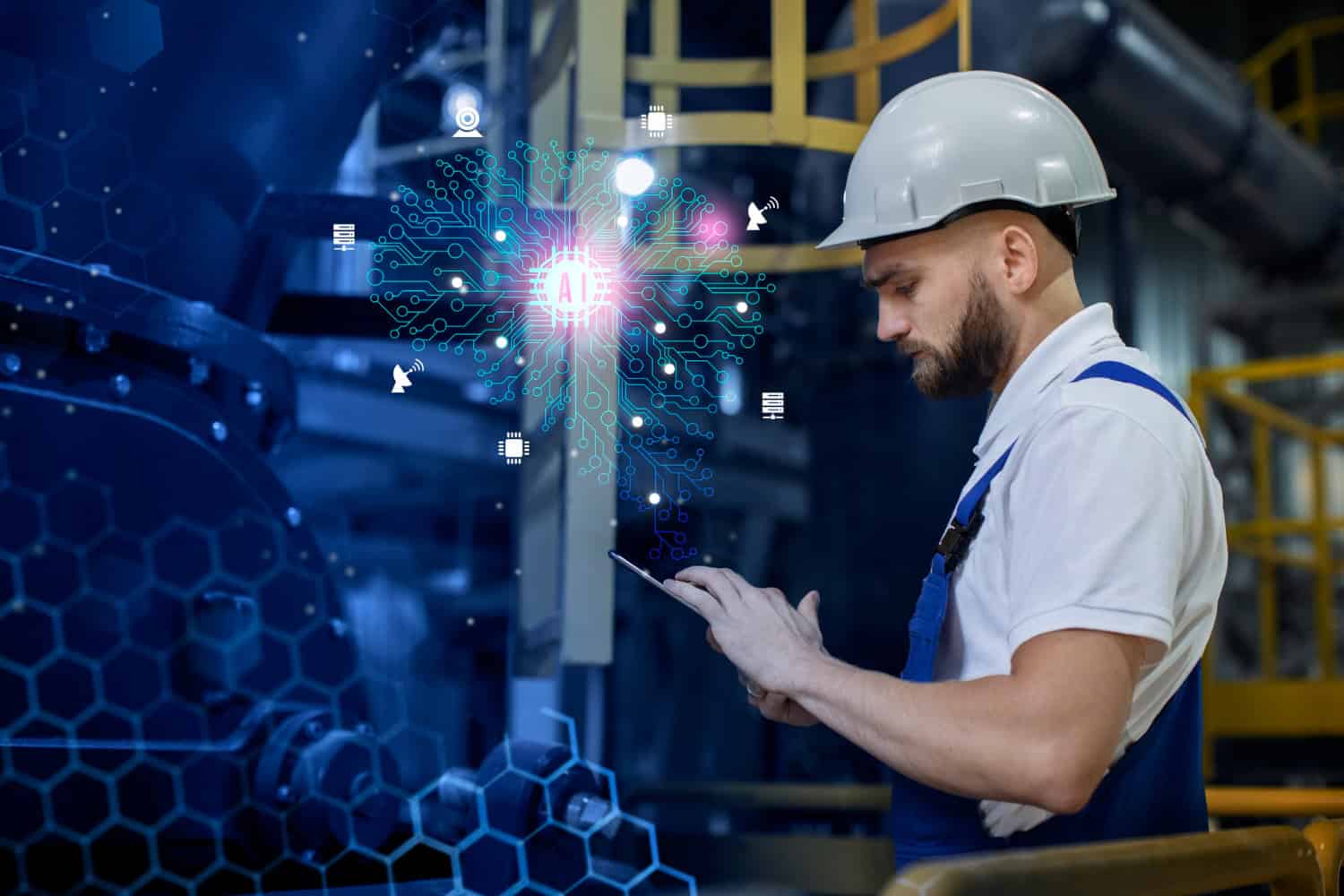 A man holding a tablet in a factory, overseeing industrial operations and monitoring processes.